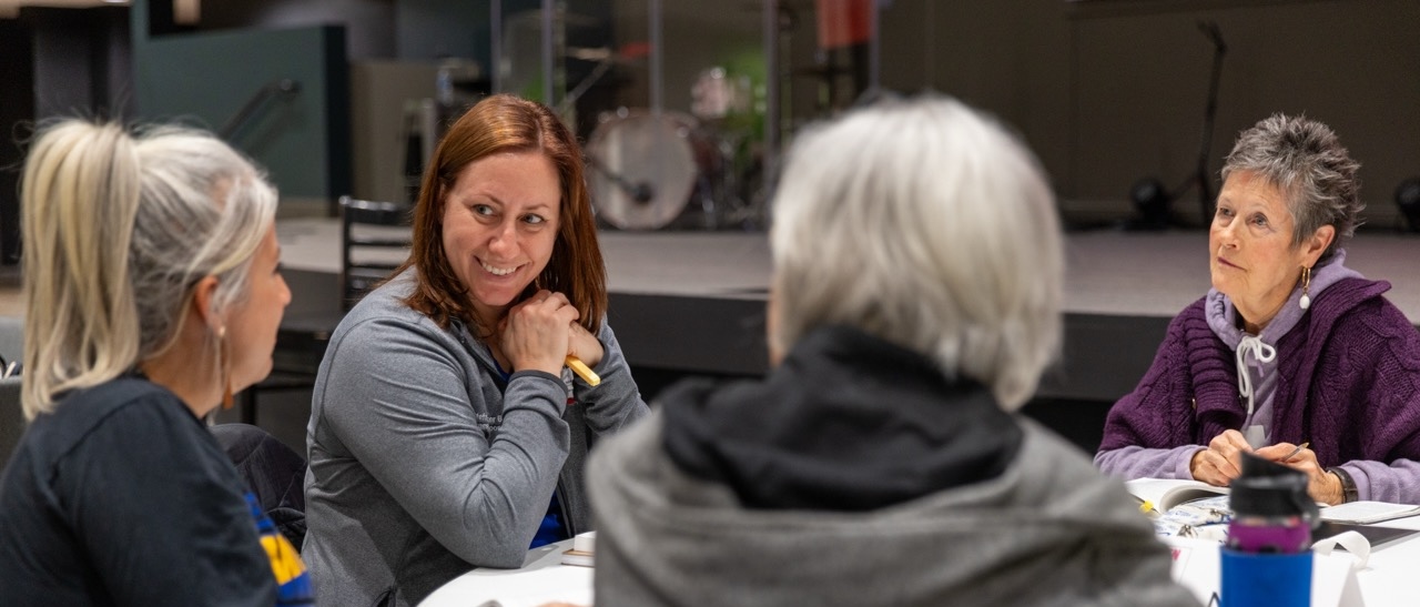 People in a classroom taking notes and learning